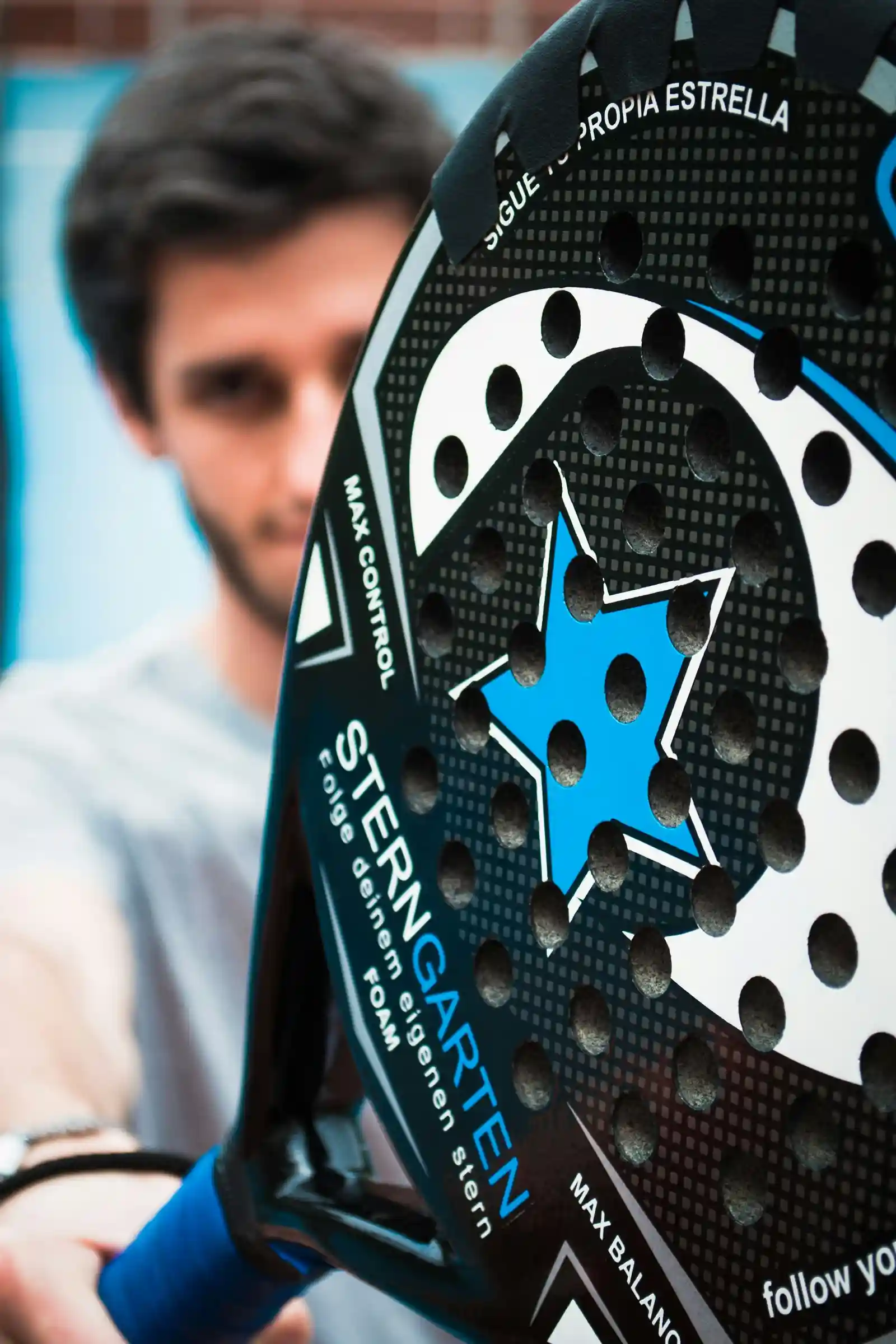a close up of a person holding a tennis racket